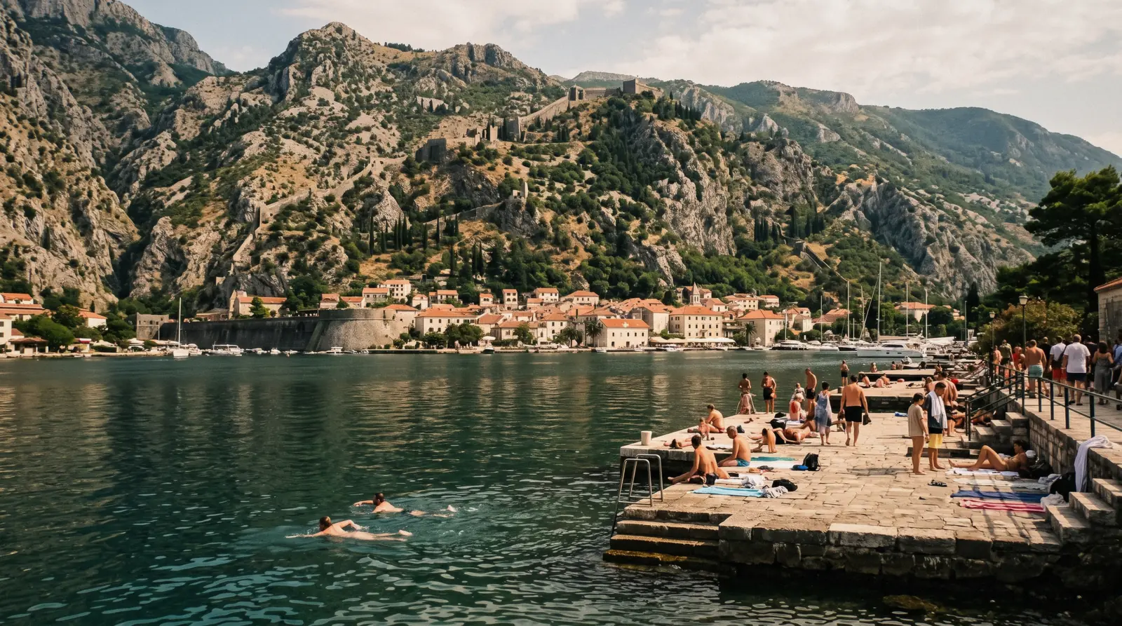 Swimmers off the stone slabs on the shore of the Bay of Kotor
