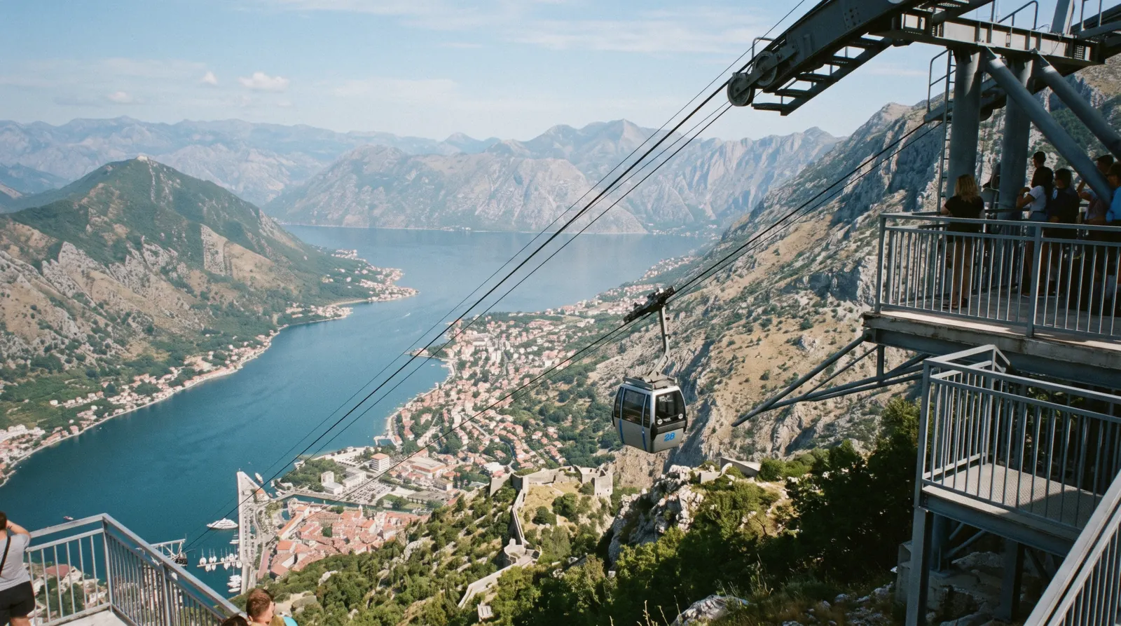 Cable car gondola climbing above the Bay of Kotor toward the Krstac ridge on Mount Lovćen