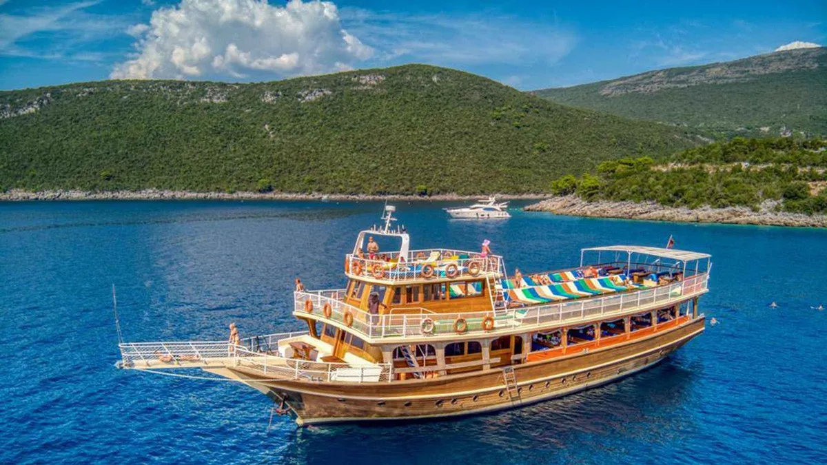Covered day-cruise ship crossing the Bay of Kotor near Perast