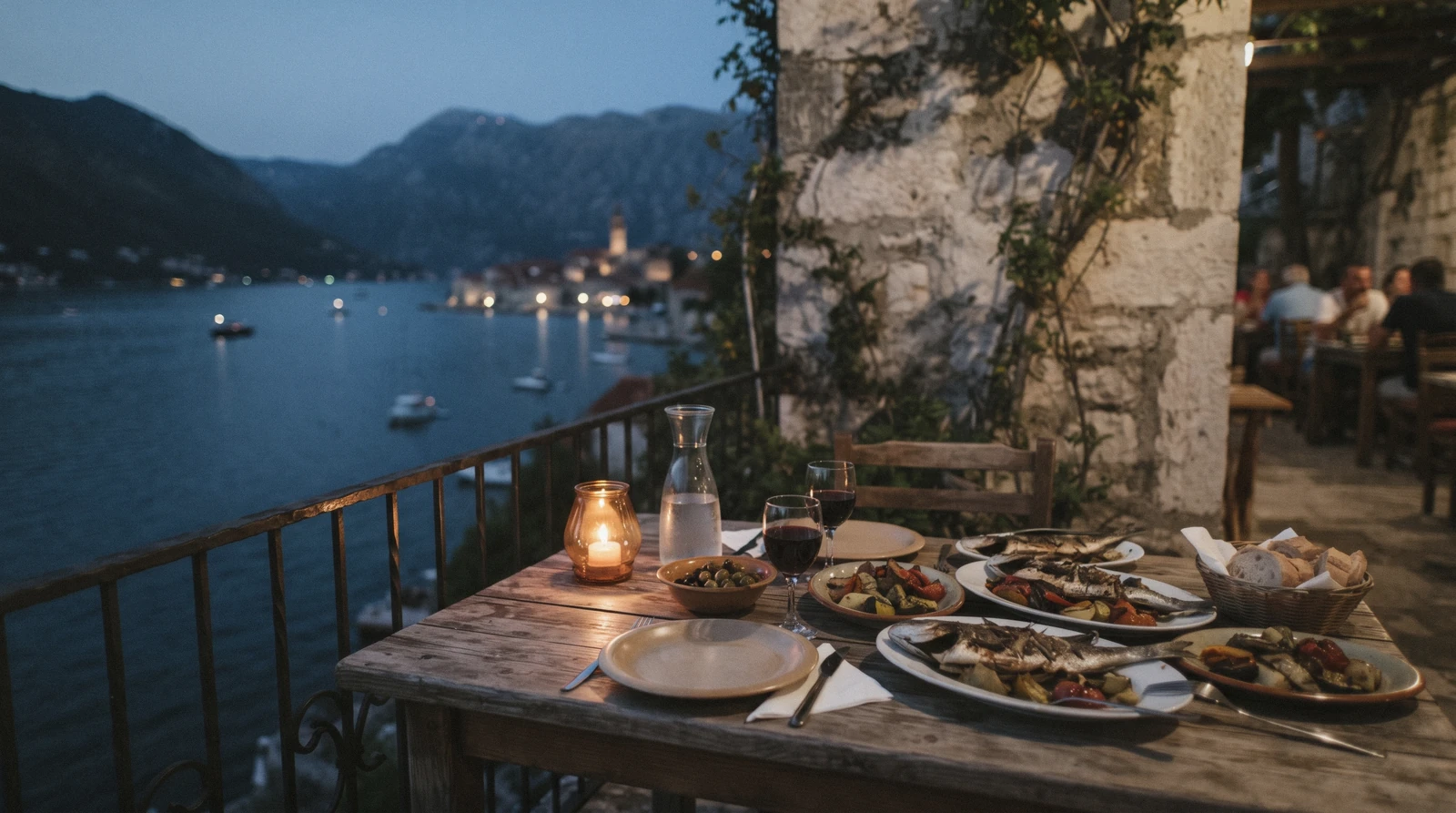 Outdoor restaurant tables on a stone square in Kotor old town